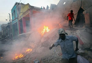Haiti then and now: January 2010: Looters take what they can from a building