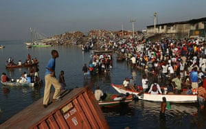 Haiti then and now: January 19, 2010: Residents queue up near a small port to evacuate the city
