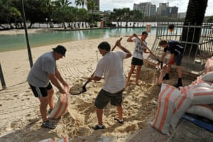 Brisbane floods: Residents use a beach on the banks of the Brisbane River to fill sand bags