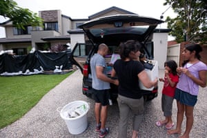 Brisbane floods: A family  in the flood-hit Brisbane suburb of Yeronga pack possessions