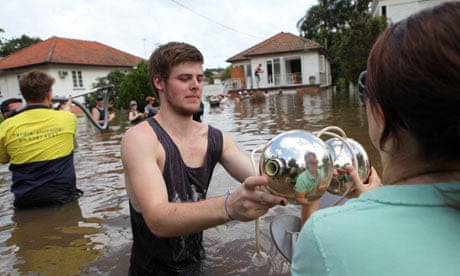 Volunteers help to rescue possessions from a flooded property in Rosalie, west of Brisbane