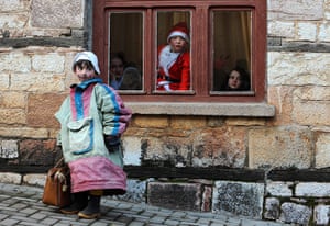 24 hours in pictures: Dressed up children watch a parade the street during a carnival, Macedonia