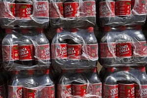 Coca products: Bottles of Coca Colla soft drink sit stacked on a street in La Paz