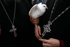 Orthodox epiphany: A Greek Orthodox priest holds a dove before a ceremony