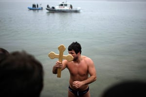 Orthodox epiphany: Nikola Kovacevic lifts up a wooden cross in the river Danube