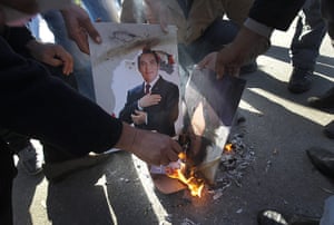 Tunisia Protests: Protestors burn a photo of Zine El Abidine Ben Ali