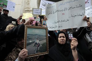 Tunisia Protests: Tunisian women hold photographs of their sons outside the Justice Ministry