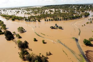 Floods in Australia: The Welcome to Rockhampton sign surrounded by floodwaters in Queensland