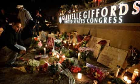 Mourners leave flowers during a candlelight vigil in Tucson for Gabrielle Giffords