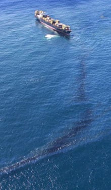 Oil streams from the Rena stuck on Astrolabe Reef in New Zealand's Bay of Plenty