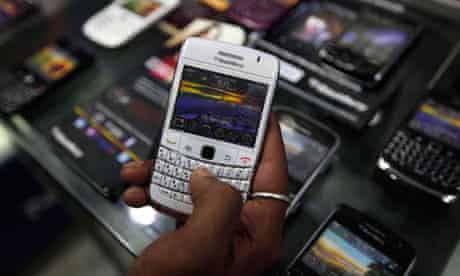 A customer holds a BlackBerry handset in Kolkata