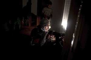 From the agencies: Manu Brabo: A sniper scans for targets from a building in Sirte