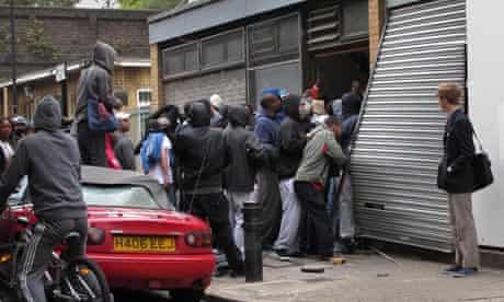Rioters force their way into a store in Hackney