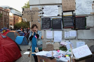Occupy London protest: A woman speaks on her phone at the information point for demonstrators