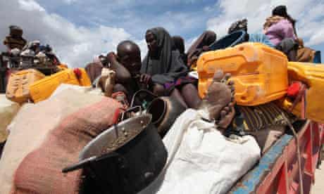 Displaced families wait to board trucks from Ala-yasir camp, Somalia