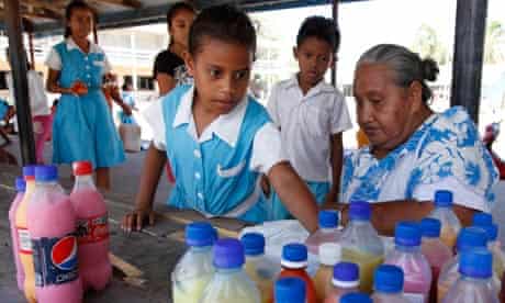 Students queue to buy drinks in recycled bottles at Nauti primary school in Funafuti, Tuvalu