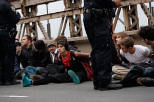 Occupy Wall Street: Protesters sit on the road in plastic handcuffs after being arrested