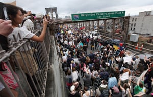 Occupy Wall Street: Supporters cheer from walkway as demonstrators cross the Brooklyn Bridge