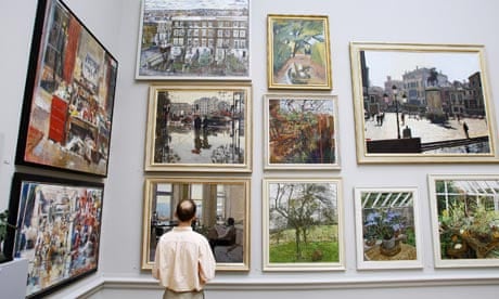Man looks at paintings