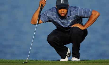 Tiger Woods lines up a putt