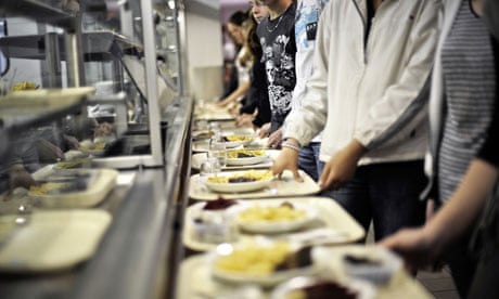 French students collect meals in their school canteen