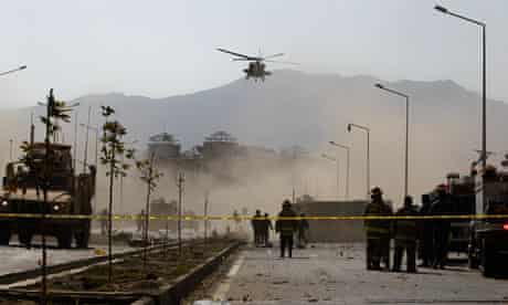 A Nato helicopter flies above the site of the bomb blast in Kabul.