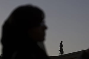 FTA: Ahmad Masood: An Afghan policeman keeps watch during Sound Central