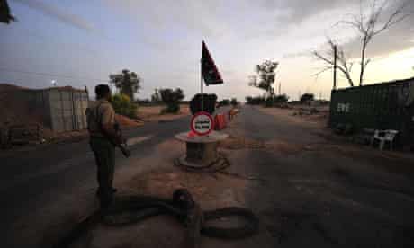 A Libyan NTC fighter mans a checkpoint near the coastal city of Misrata