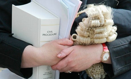 A female barrister holds her wig
