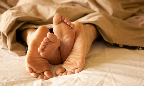 Feet of couple in bed