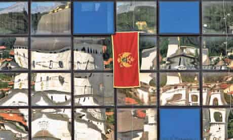 An orthodox church reflected in the panes of a modern building in Podgorica, Montenegro 