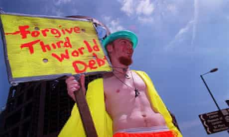A protester in the City of London holds a placard advocating the abolition of Third World Debt.