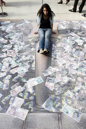 3D pavement art: 24 July 2008: A woman poses in Kurt Wenner's illustration of an open vault