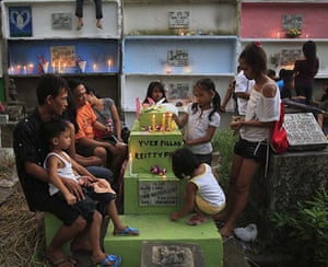 All saints day: People gather near the graves of their relatives in Manila