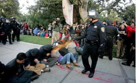 A University of California, Davis, police officer deploys pepper spray on student Occupy protesters