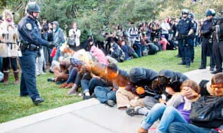 A police officer pepper-sprays students at an Occupy protest at University of California, Davis