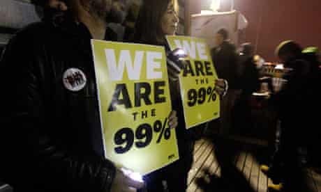 Occupy Wall Street demonstrators hold signs