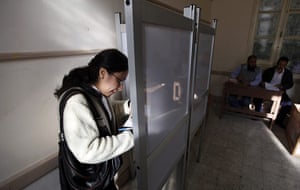 Egypt elections: An Egyptian woman votes inside a polling station in Assuit