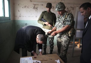 Elections in Egypt: An election official opens a ballot box
