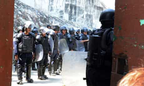 Policemen stand guard at the raided jail in Acapulco, Mexico