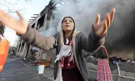 A woman gestures at Roma camp in Turin
