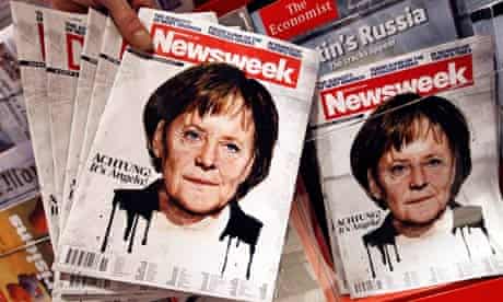Copies of a Newsweek magazine bearing a picture of German Chancellor Angela Merkel