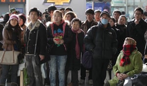 Reaction to Kim Jong il: Passengers watch a TV news reporting about the death of Kim Jong Il