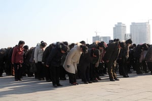 Kim Jong-il death: People gather in front of a bronze statue of Kim Il Sung in Pyongyang
