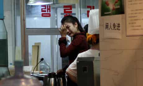 A waitress cries in a North Korean restaurant in Beijing