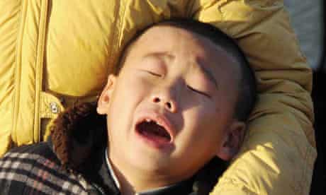 A North Korean child is overcome by grief at the death of Kim Jong Il