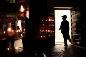 Hanukkah: An Ultra-Orthodox Jewish man passes by candles in Jerusalem