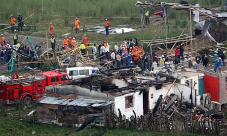 Rescuers and firemen work on the site where a pipeline exploded in Risaralda, Colombia