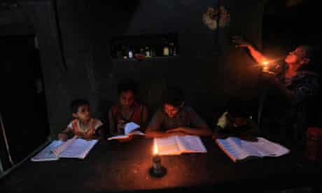 Indian children studying by candlelight
