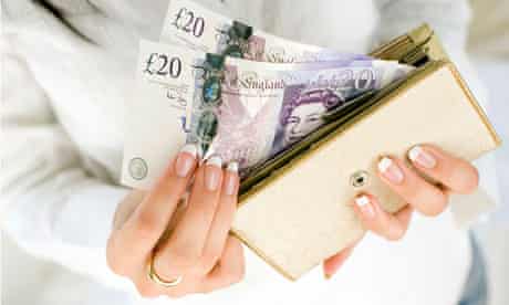 Woman with 20 pound notes in purse